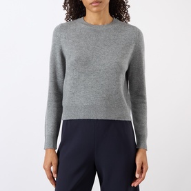 Model wearing Nili Lotan pebble grey heather knit crew-neck sweater, styled with navy wide-leg trousers.