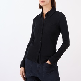 Model wearing Nili Lotan black 100% wool shirt with button-front placket, slim fit, and long sleeves, styled with navy trousers.