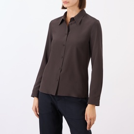 Model wearing Nili Lotan chocolate brown 100% silk shirt with pointed collar, long sleeves and button front, styled with navy trousers.