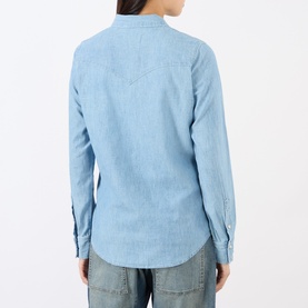 Model wearing Nili Lotan indigo chambray cotton shirt, rear view, with relaxed fit and long sleeves, styled with blue jeans.