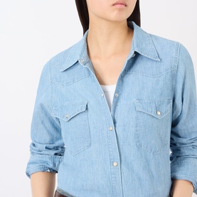 Model wearing Nili Lotan Indigo Chambray shirt, chest patch pockets with snap buttons, relaxed fit, worn over white top.