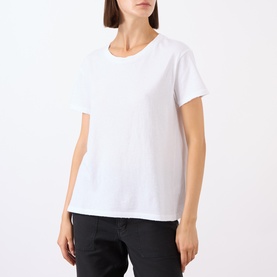 Model wearing Nili Lotan white cotton T-shirt with crew neck and short sleeves, styled with black trousers.