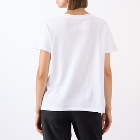 Model wearing Nili Lotan white cotton T-shirt, shown from behind, styled with black trousers.