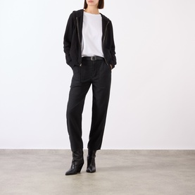 Model wearing Nili Lotan white cotton T-shirt, styled with black zip-up hoodie, dark trousers and black ankle boots.