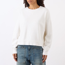 Model wearing Nili Lotan Gladys Sweatshirt in ecru, crew neck, dropped shoulders, cropped length, styled with blue jeans.
