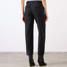Model wearing Nili Lotan carbon cotton trousers, rear view, styled with black ankle boots. Straight leg with back patch pockets.