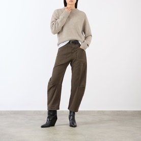 Model wearing Nili Lotan trousers in Vintage Washed Dark Walnut, styled with a beige knit jumper and black ankle boots.