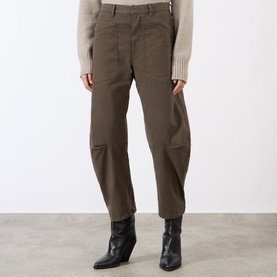Model wearing Nili Lotan trousers in Vintage Washed Dark Walnut, styled with a cream knit and black ankle boots.