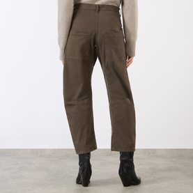 Model wearing Nili Lotan trousers in Vintage Washed Dark Walnut, rear view, styled with a cream knit and black heeled boots