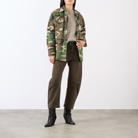 Model wearing Nili Lotan trousers in Dark Walnut, styled with camo jacket and black ankle boots.