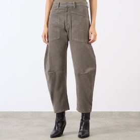Model wearing Nili Lotan Shon Cargo Trousers in Sage Grey, barrel-leg fit with patch pockets, styled with black ankle boots.