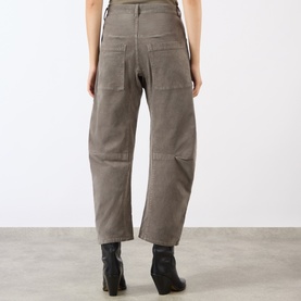 Model wearing Nili Lotan Shon Cargo Trousers in Sage Grey, showing back patch pockets and dart-detailed legs, styled with black ankle boots.