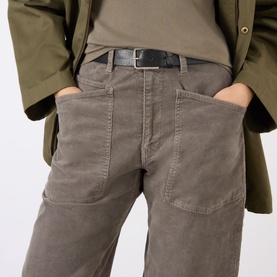 Model wearing Nili Lotan Shon Cargo Trousers in Sage Grey corduroy with patch pockets and black leather belt, styled with khaki jacket.