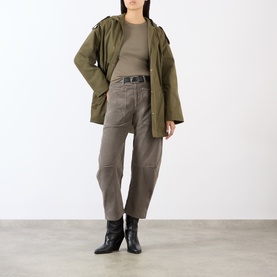 Model wearing Nili Lotan Shon Cargo Trousers in Sage Grey with khaki parka jacket and black ankle boots.