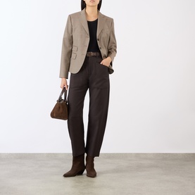 Model wearing Nili Lotan Brown Herringbone wool trousers, styled with a black top, taupe blazer, brown ankle boots and a brown handbag.