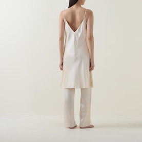 Model wearing Olivia von Halle Elvira Camisole Pyjama Set in Bone silk, shown from behind with V-back cami and wide-leg trousers