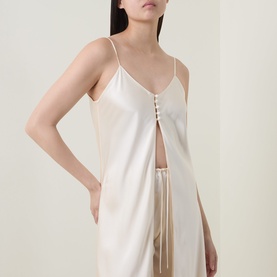 Model wearing Olivia von Halle Elvira Camisole Pyjama Set in bone silk, featuring V-neck cami with lace-up detail and wide-leg trousers