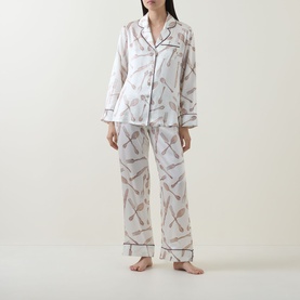 Model wearing Olivia von Halle Lila Sevilla Silverware Pyjama Set in white silk with all-over silverware print and contrast piping