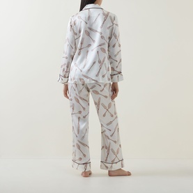 Model wearing Olivia von Halle Lila Sevilla Silverware Pyjama Set in white silk with allover silverware print, shown from back