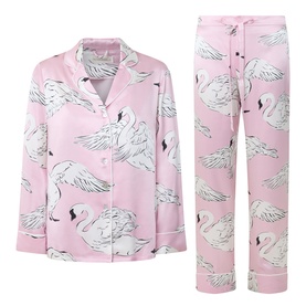 Olivia von Halle Lila Selene Swan Pyjama Set in pink, long-sleeve button-up top and full-length trousers with white swan print