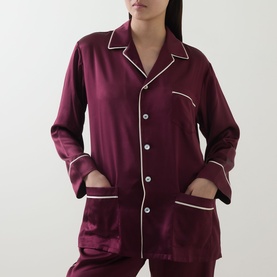 Model wearing Olivia von Halle Yves Silk Pyjama Set in Raisin, button-front top with white contrast piping and patch pockets