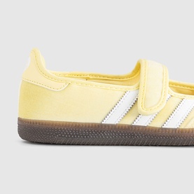 Adidas Samba almost yellow suede trainer with white three-stripe detail, hook-and-loop strap, and dark gum sole.