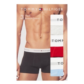 Tommy Hilfiger 3-pack stretch cotton trunks in grey, red and blue with branded waistband, shown on model and packaged.