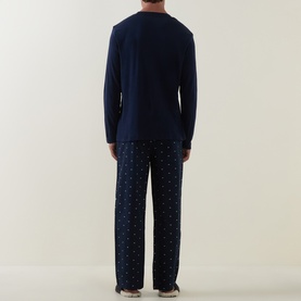 Model wearing Tommy Hilfiger Blue Spell Pyjamas Set, rear view, navy top with printed flag AOP trousers in Carbon Navy