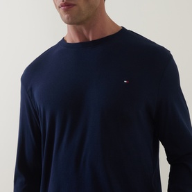 Model wearing Tommy Hilfiger Pyjamas Set in Carbon Navy, long-sleeve crew-neck top with small flag logo on chest.