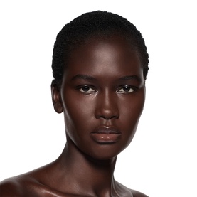 Model wearing Victoria Beckham Posh Gloss in Bikini, a subtle nude lip gloss finish on bare skin