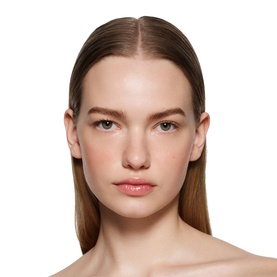 Model wearing Victoria Beckham Posh Gloss in Bikini, a sheer nude-pink lip gloss finish, paired with a natural, glowing complexion
