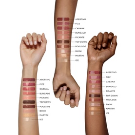 Victoria Beckham Posh Gloss lip gloss shade swatches shown across three arms with varying skin tones, including Bikini shade