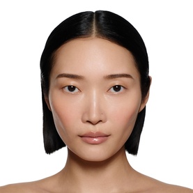 Model with Victoria Beckham Posh Gloss in Bikini, a sheer nude-pink lip gloss finish shown on model's lips