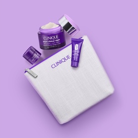Clinique skincare gift set with purple jar, eye cream tube, and mini product in white zip pouch on lilac background