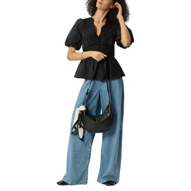 Model wearing Whistles black puff-sleeve peplum top with V-neckline, styled with wide-leg blue jeans and carrying a black shoulder bag