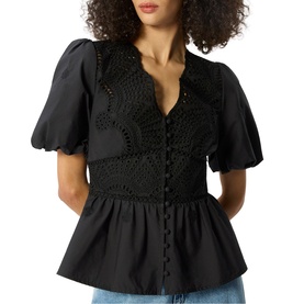 Model wearing Whistles black peplum blouse with crochet lace bodice, puff sleeves, and button-front detail