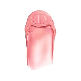Dior rosy highlighter balm swatch in shade 106 Pomelo, showing soft pink tint with embossed CD logo on cap