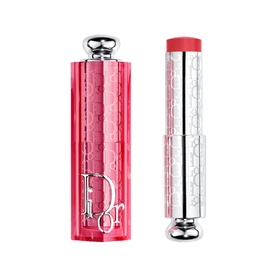 Dior Addict Lip Glow in 106 Pomelo, pink faceted case with silver detailing shown open beside coral-toned bullet