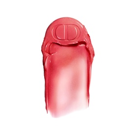 Dior highlighter swatch in shade 106 Pomelo, a sheer coral-pink tone with embossed CD logo on bullet tip