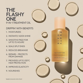 Fenty Hair The Flashy One 9-in-1 Treatment Oil bottle displayed with gold liquid droplets and benefits list on cream background.