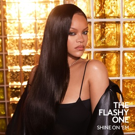 Model with Fenty Hair The Flashy One hair oil, showcasing long, sleek, glossy straight hair. Wearing black top with delicate necklace.