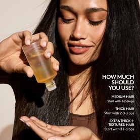 Model with Fenty Hair Hair Oil, holding small bottle, demonstrating usage guide for medium, thick and extra thick hair types