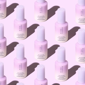 Fenty Hair Dry Shampoo in lilac bottle with white pump cap, shown in repeating flat-lay pattern on pink background