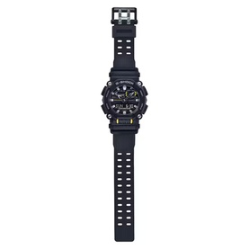Casio G-Shock style watch in black and grey with rubber strap, yellow accent details, and analogue-digital dial face