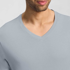 Model wearing Hanro Pyjamas Set in Celestial Night, close-up of pale blue v-neck top with clean neckline finish