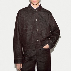 Model wearing Jigsaw burgundy denim jacket with button front and chest pockets, styled with matching wide-leg denim trousers.