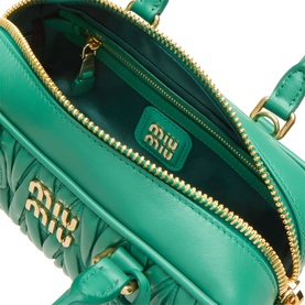Miu Miu matelass&eacute; calfskin crossbody bag in mango green, open zip showing gold-tone hardware and branded interior lining