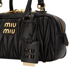 Miu Miu Nero matelass&eacute; leather crossbody bag with gold-tone hardware, logo lettering, and branded luggage tag detail.