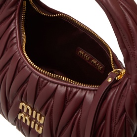 Miu Miu bordeaux matelass&eacute; leather crossbody bag, open showing interior lining, gold-tone zip and logo hardware