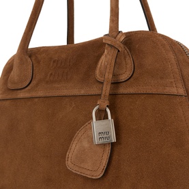 Miu Miu Cacao suede tote bag with silver padlock charm and knotted top handles, close-up detail shot